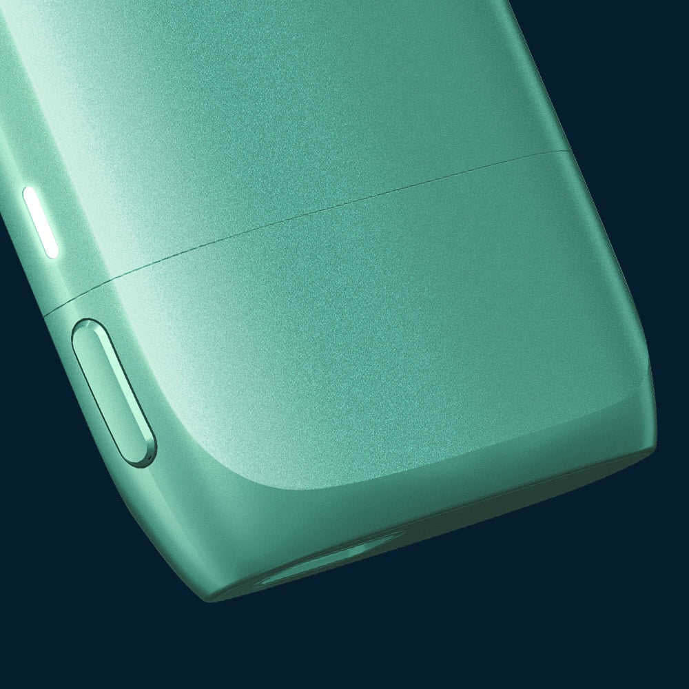 Vuse | Gros plan sur un appareil électronique élégant, de couleur vert menthe, aux bords arrondis et muni d'un petit bouton sur le côté, sur fond sombre. | Cigarettes Electroniques et Recharges